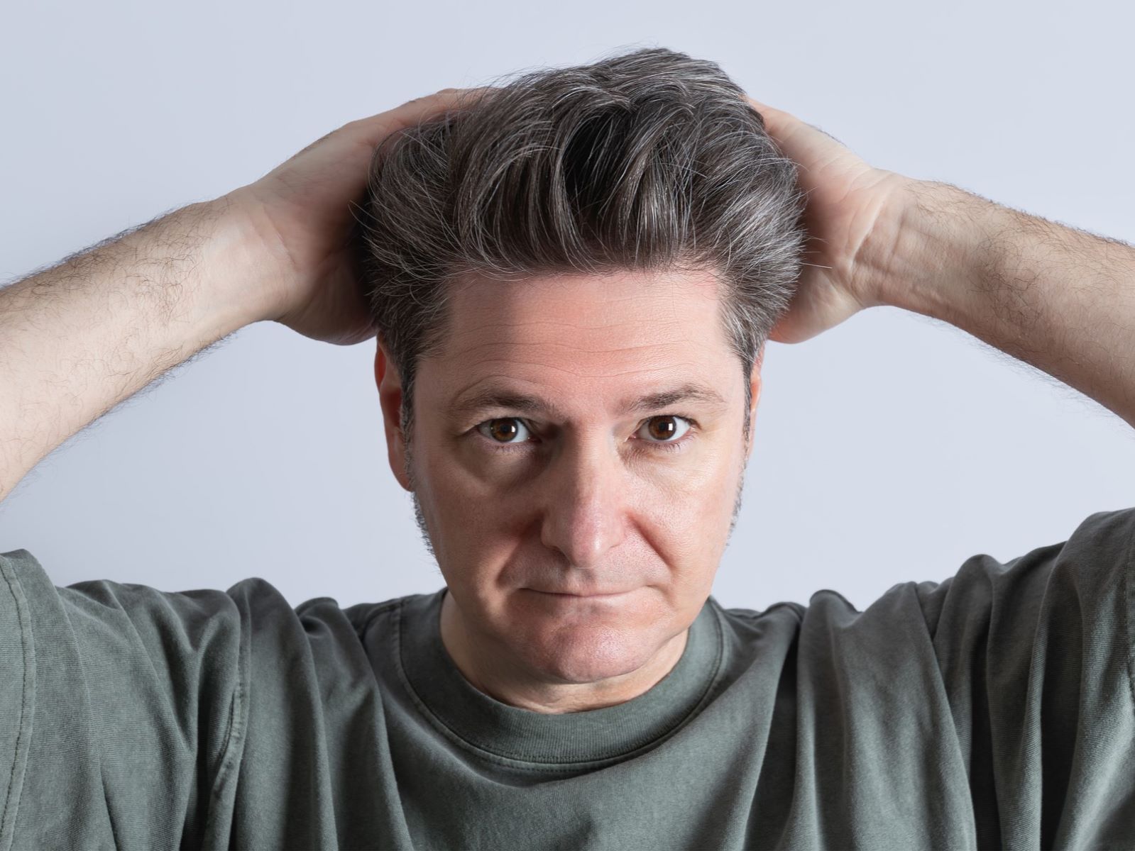 Middle-aged man with bouffant toup&eacute;e
