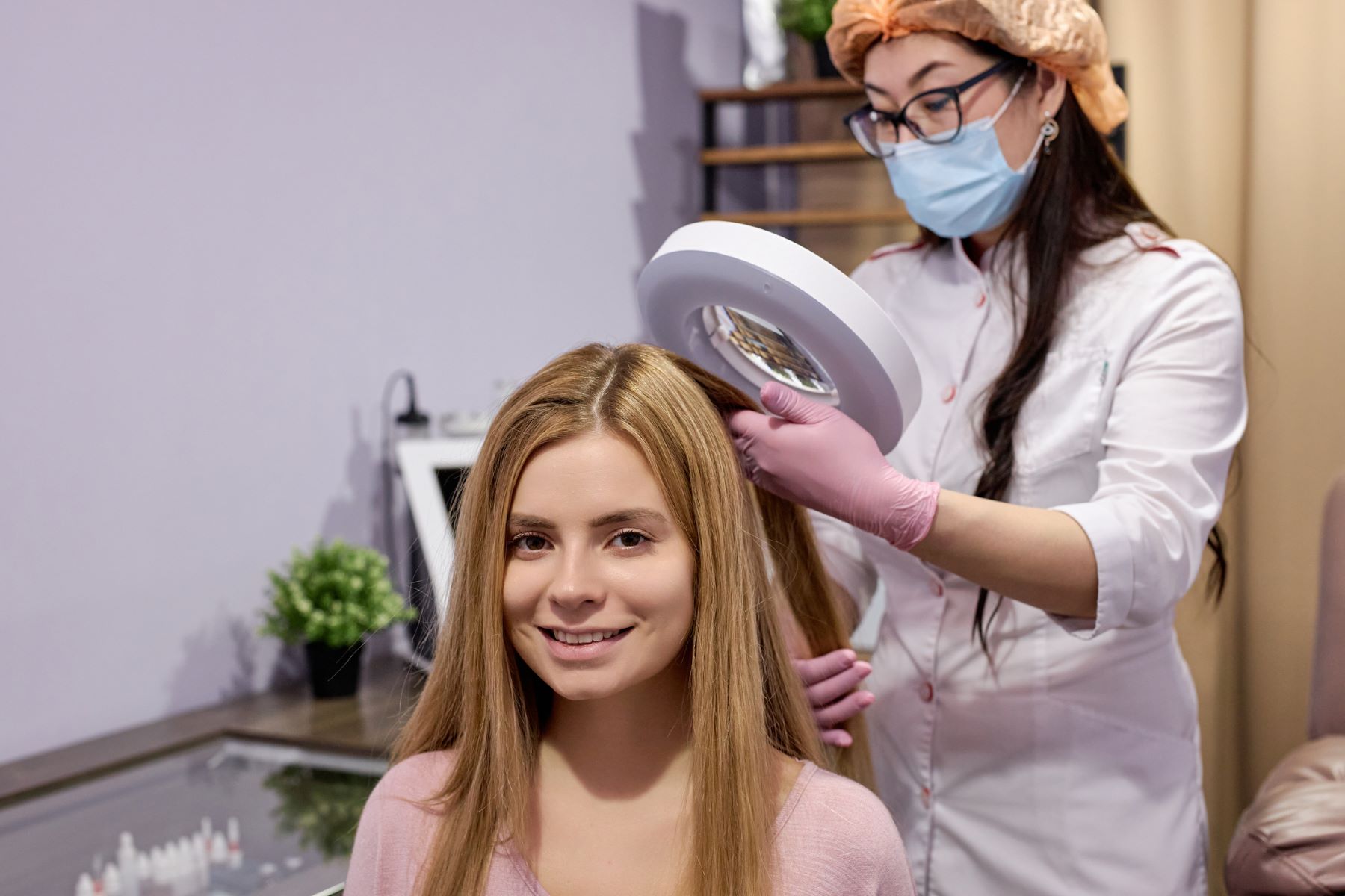 Woman being examined by a hair doctor