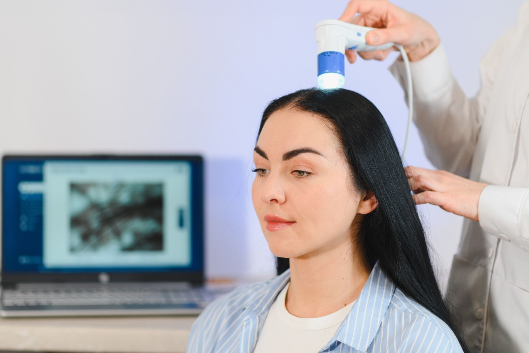 Trichologist diagnosing woman&rsquo;s hair loss